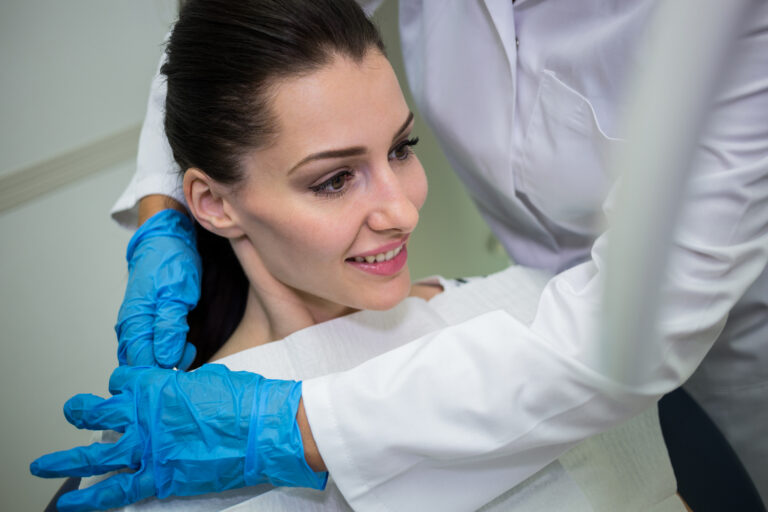 Dentist preparing patient for dental check-up in dental clinic